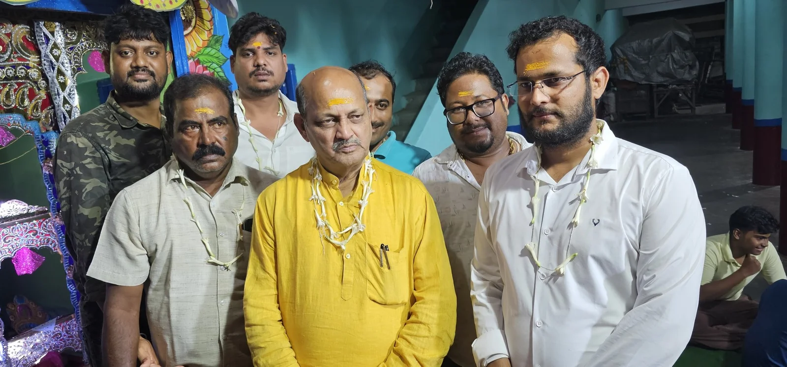 Manmohan Samal standing with a group of people at a community gathering.