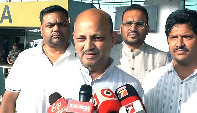 Manmohan Samal making a statement to reporters, flanked by three party colleagues.